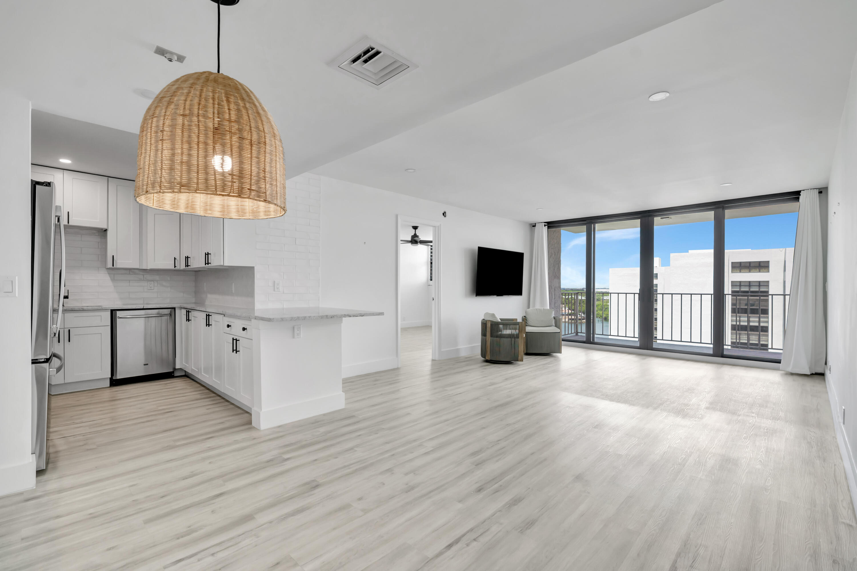336 Golfview Road, Unit 1104 North Palm Beach, FL 33408 - Photo 2 of 54 a view of a kitchen with furniture a fireplace and wooden floor