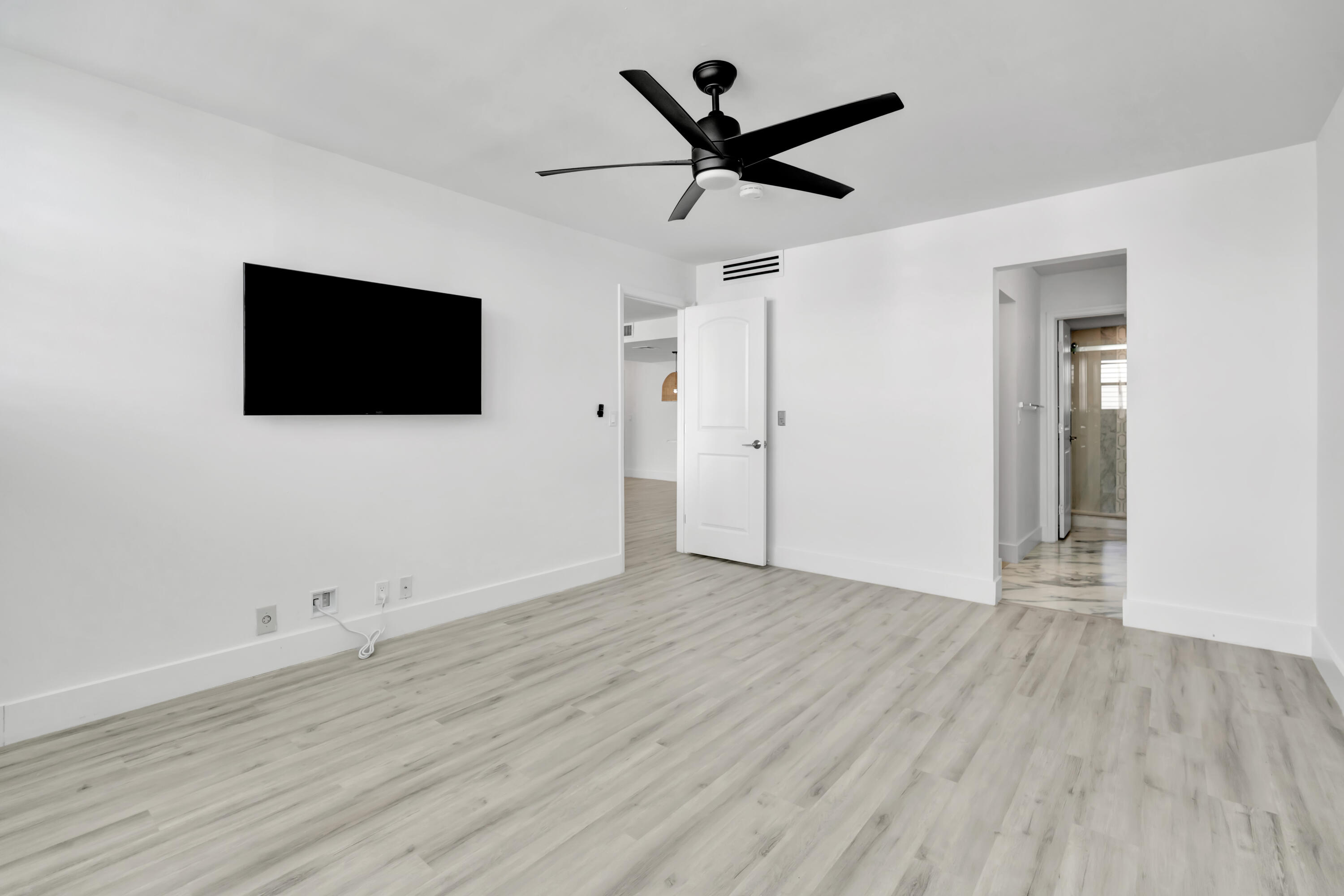 336 Golfview Road, Unit 1104 North Palm Beach, FL 33408 - Photo 24 of 54 an empty room with wooden floor and windows