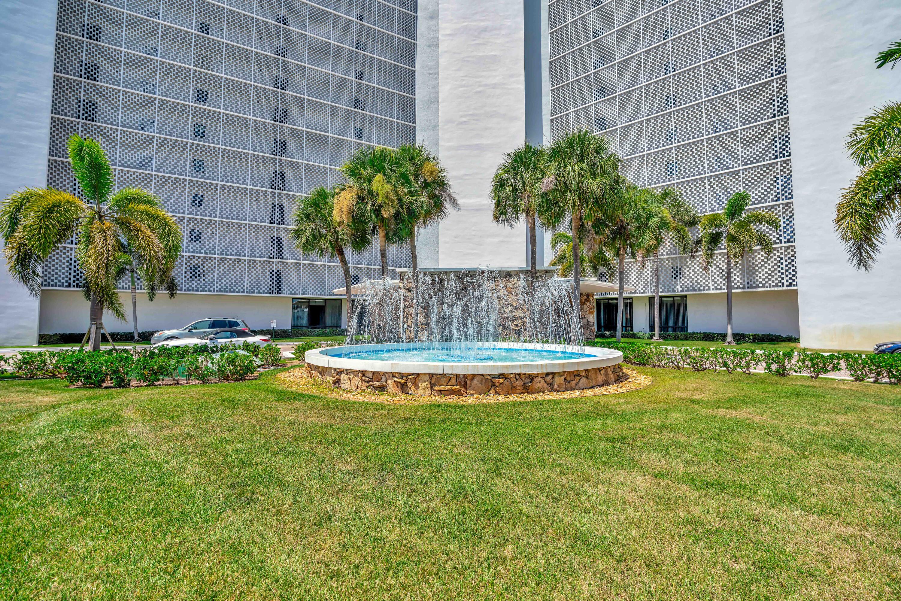 336 Golfview Road, Unit 1104 North Palm Beach, FL 33408 - Photo 44 of 54 a view of a house with a swimming pool and a yard