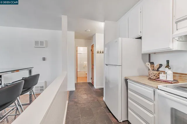 a kitchen with a refrigerator and cabinets