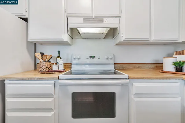 a stove top oven sitting inside of a kitchen