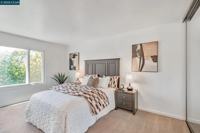 a spacious bedroom with a bed and a window