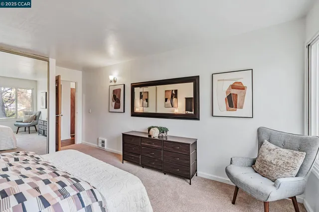 a bedroom with a bed and a couch