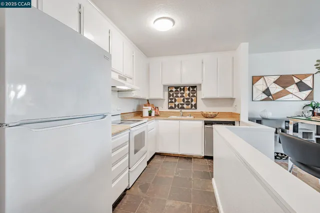 a kitchen with a white cabinets and white appliances