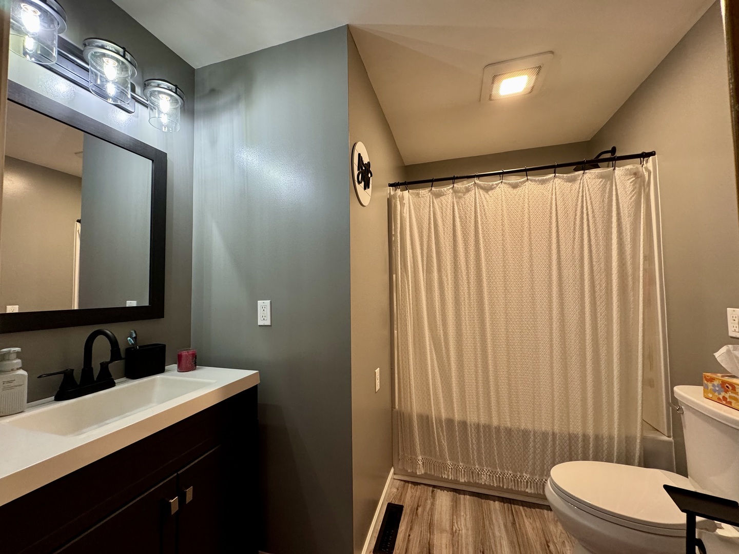 212 Mitchell Street Benton, IL 62812 - Photo 33 of 40 a bathroom with a sink a toilet a mirror and shower curtain