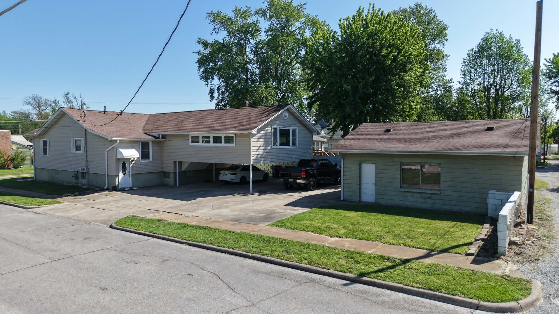 212 Mitchell Street Benton, IL 62812 - Photo 4 of 40 a front view of a house with a garden and trees