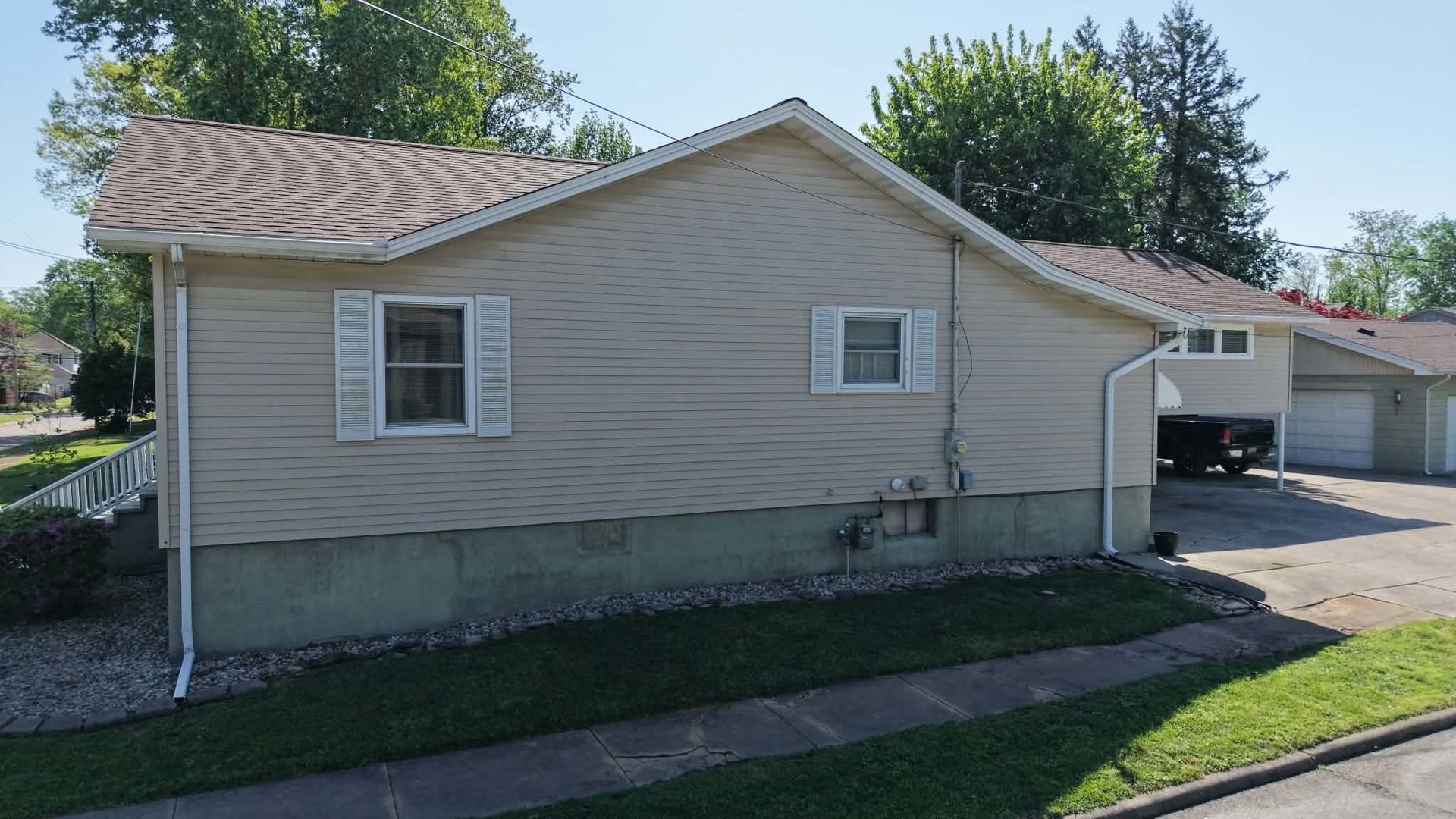 212 Mitchell Street Benton, IL 62812 - Photo 7 of 40 a view of a white house next to a yard and large trees