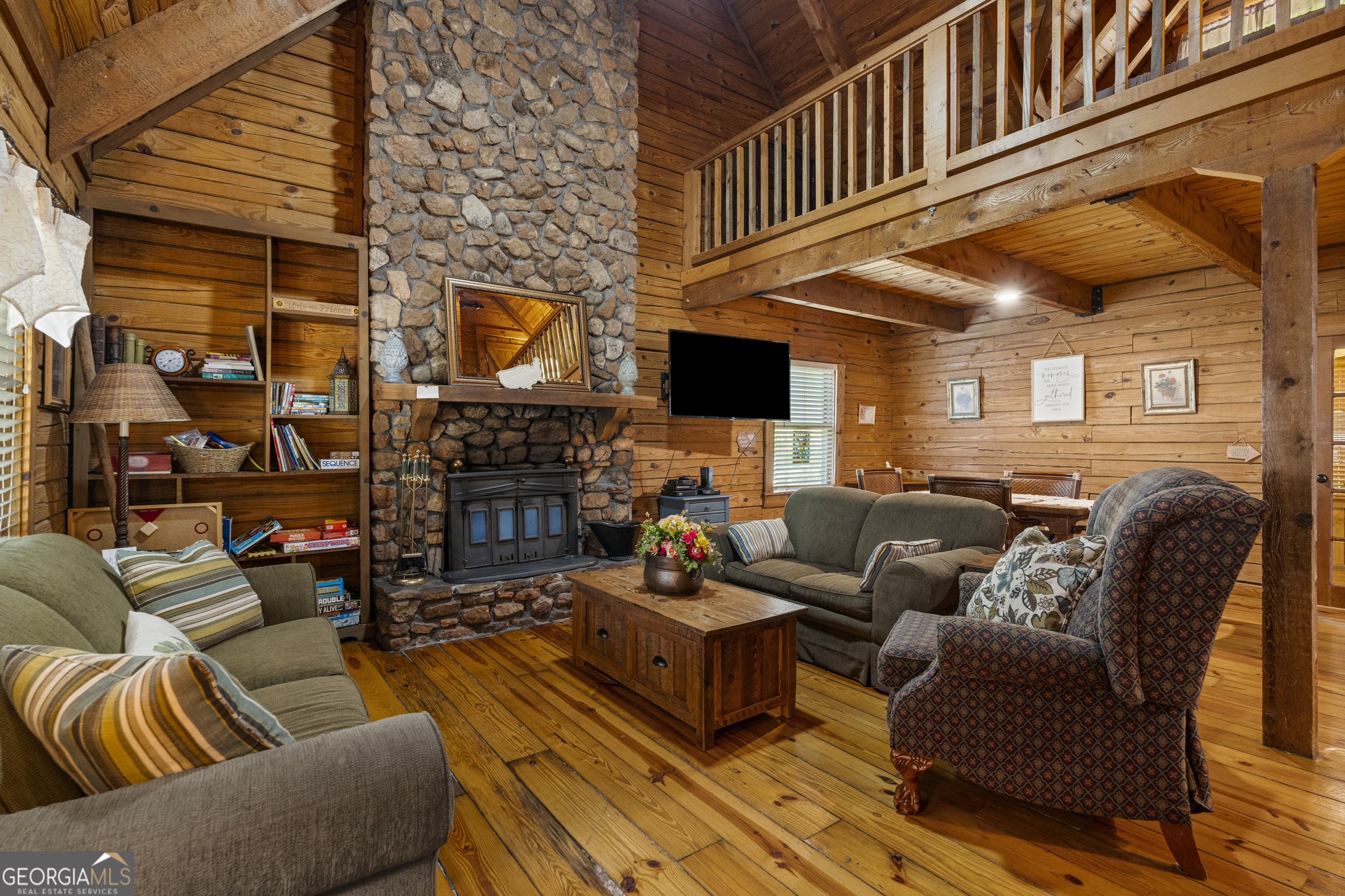 299 South L Street Hamilton, GA 31811 - Photo 2 of 36 a living room with furniture a fireplace and a flat screen tv