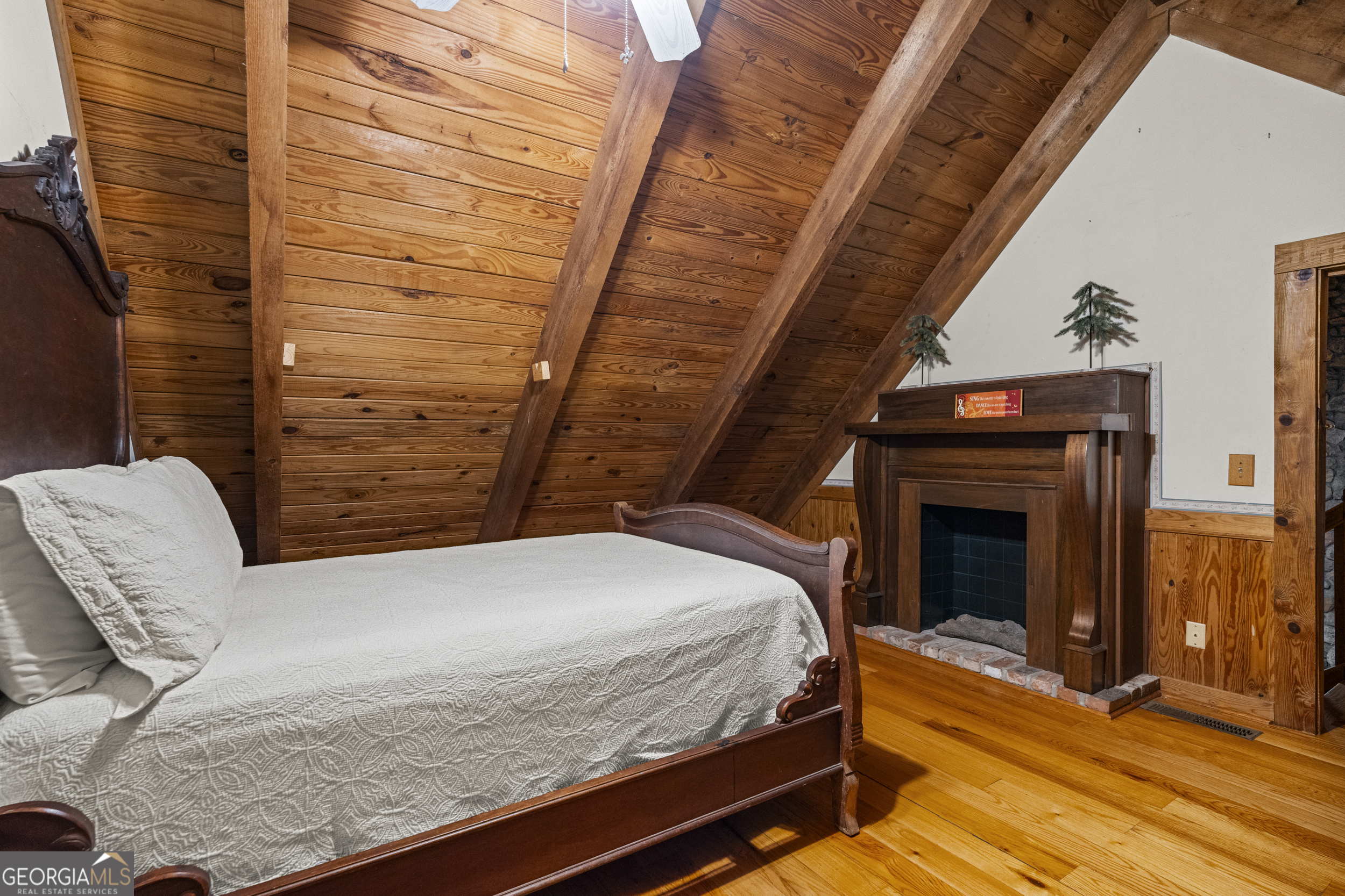 299 South L Street Hamilton, GA 31811 - Photo 22 of 36 a bedroom with a bed and a fireplace