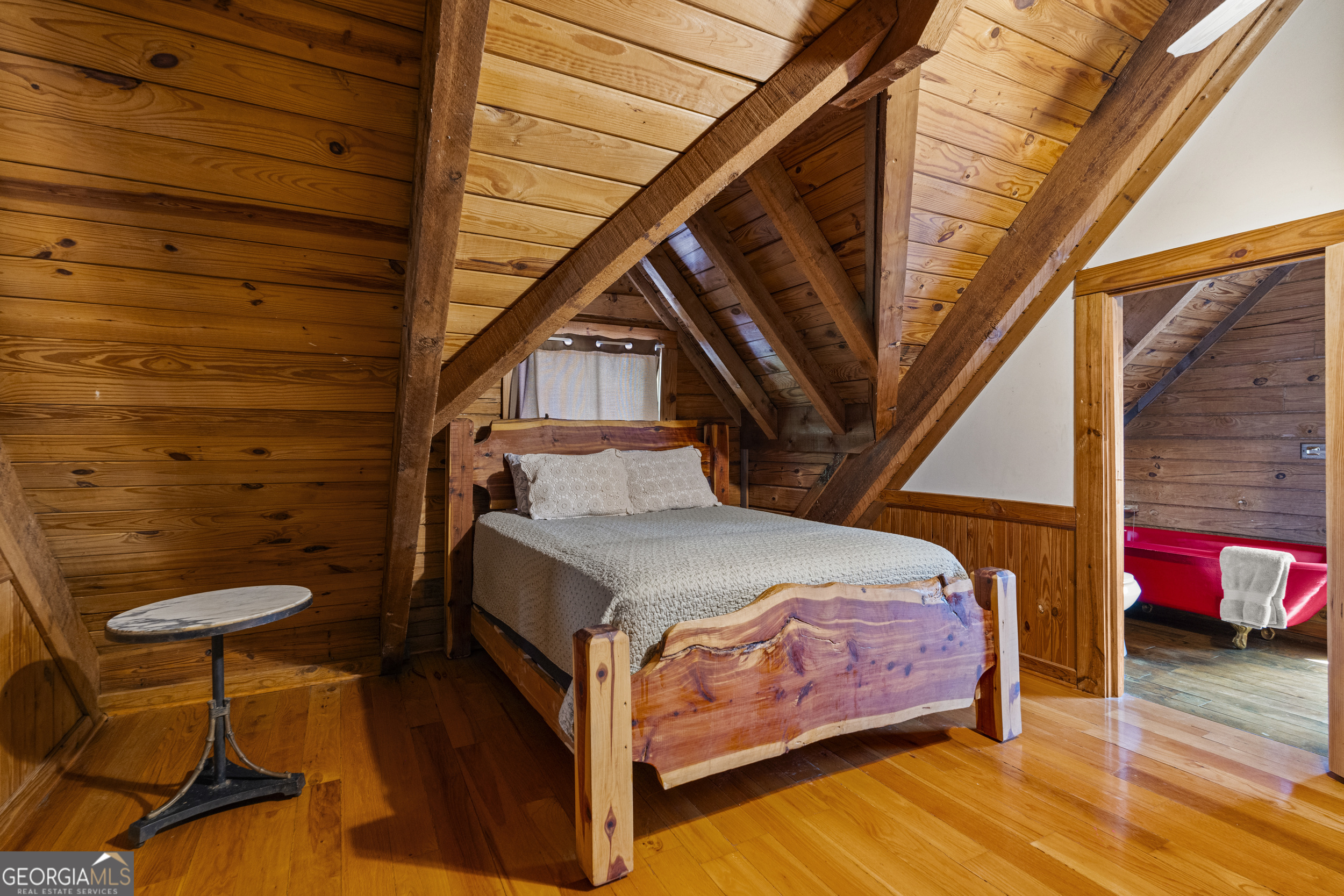 299 South L Street Hamilton, GA 31811 - Photo 23 of 36 a bedroom with a bed and wooden floor