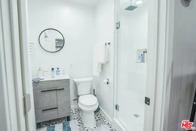 a bathroom with a toilet a sink and a mirror