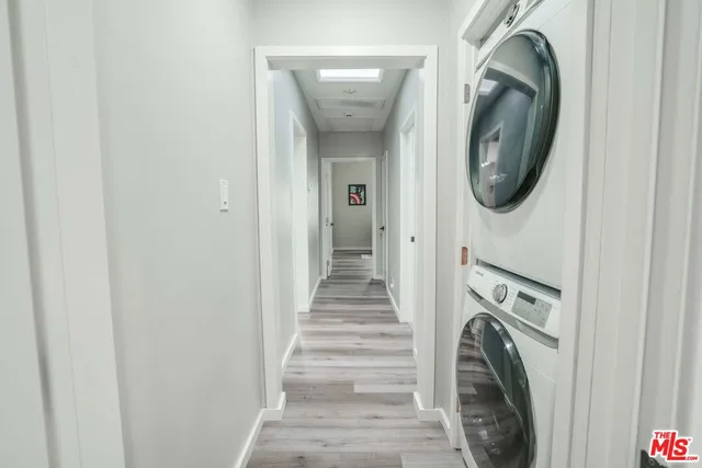 a view of a hallway with washer and dryer