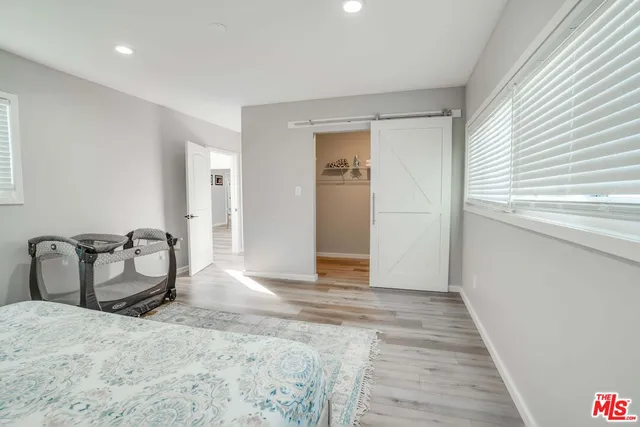 a bedroom with furniture and a window