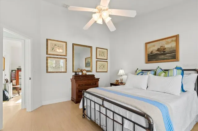 a bedroom with a large bed and a chandelier