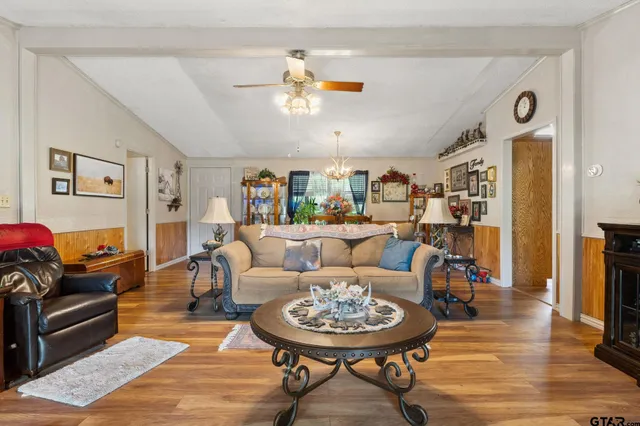 a living room with furniture and a wooden floor