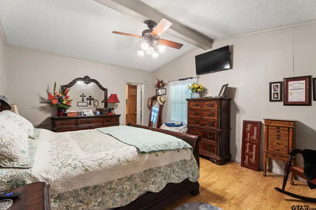 a bed room with a bed a television and a television