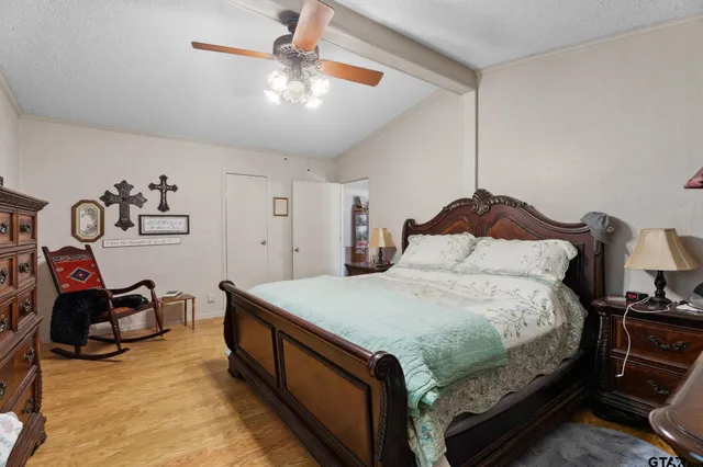 a bedroom with a bed and a chandelier