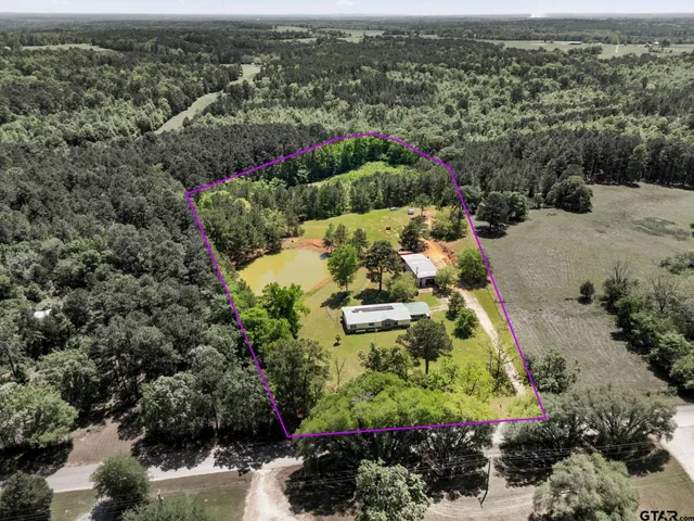 an aerial view of a houses with a yard
