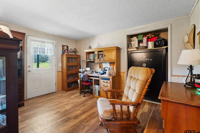 a view of a workspace with furniture and wooden floor