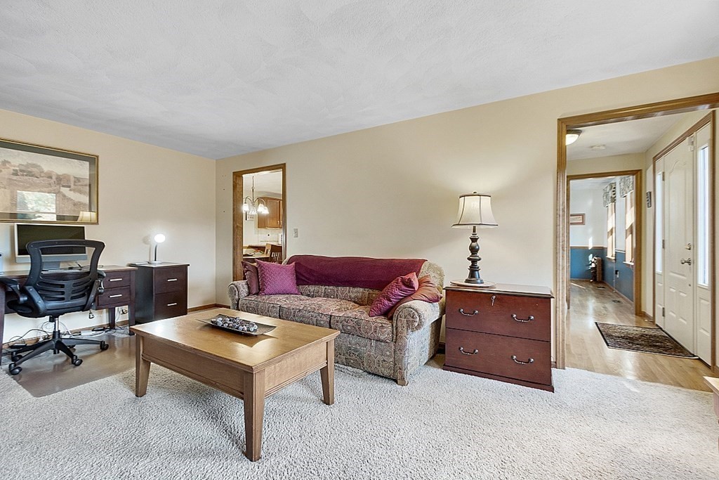 5 Abby Road Westford, MA 01886 - Photo 22 of 41 a living room with furniture a couch and a flat screen tv