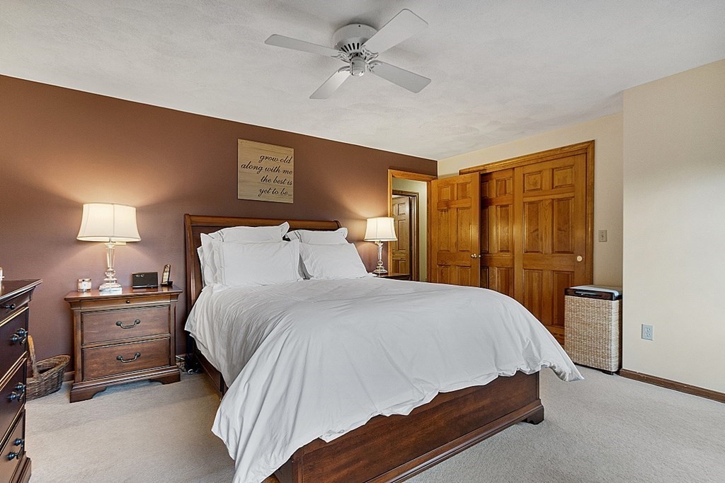 5 Abby Road Westford, MA 01886 - Photo 24 of 41 a bedroom with a bed and a chandelier