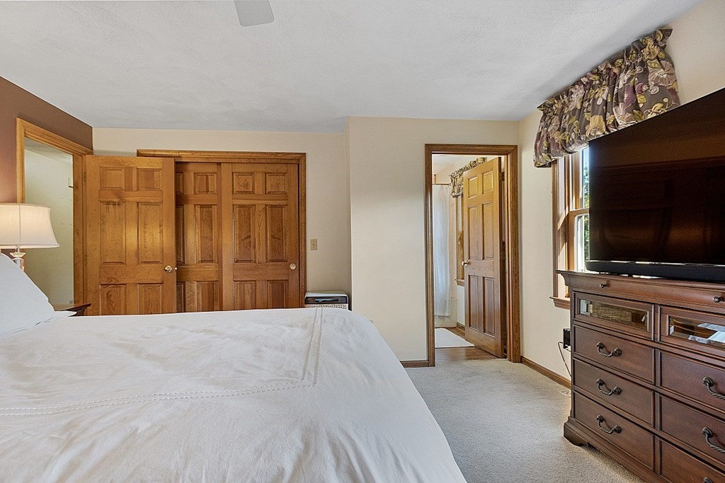 5 Abby Road Westford, MA 01886 - Photo 25 of 41 a bedroom with a bed and flat screen tv