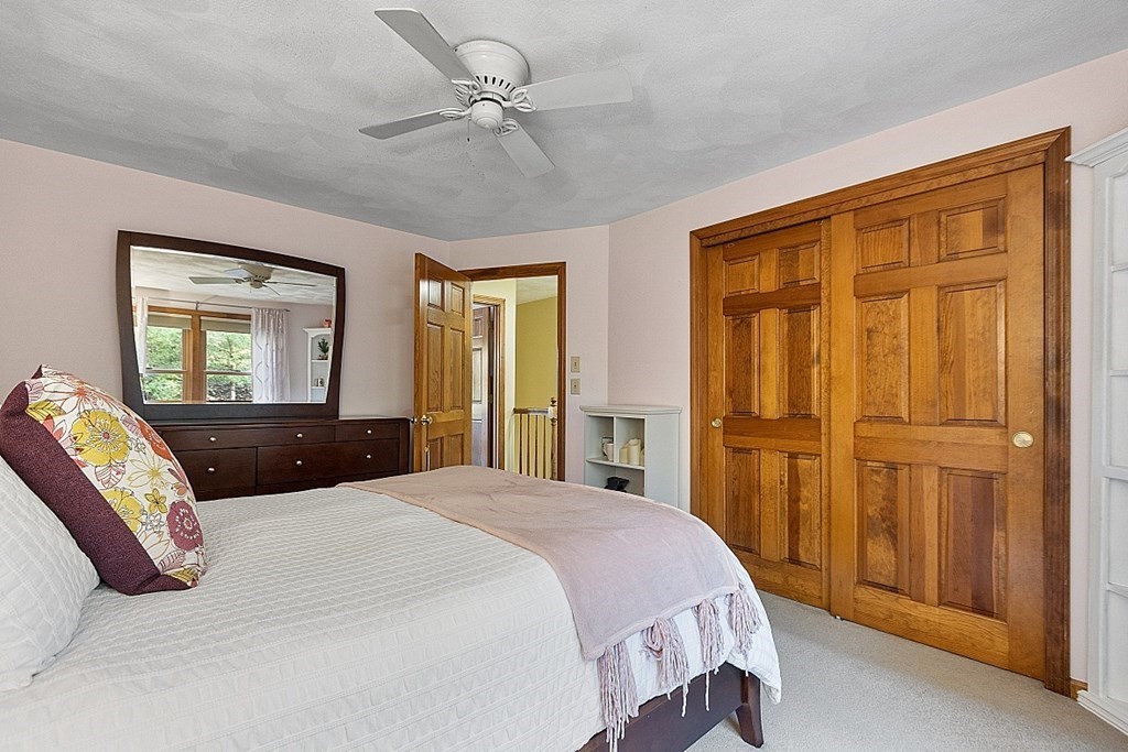 5 Abby Road Westford, MA 01886 - Photo 28 of 41 a bedroom with a large bed and ceiling fan