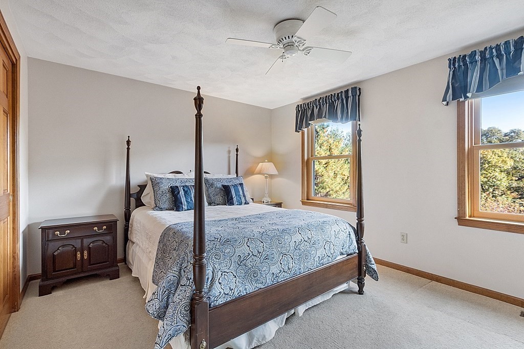 5 Abby Road Westford, MA 01886 - Photo 29 of 41 a bedroom with a bed a chandelier and a window