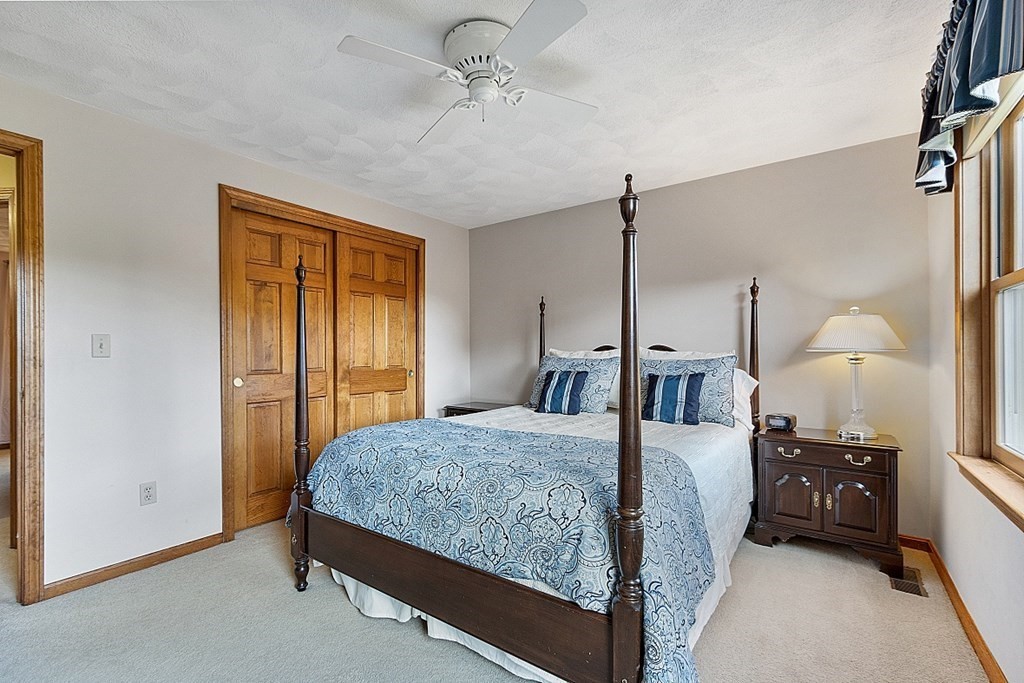 5 Abby Road Westford, MA 01886 - Photo 30 of 41 a bedroom with a bed and dresser with mirror