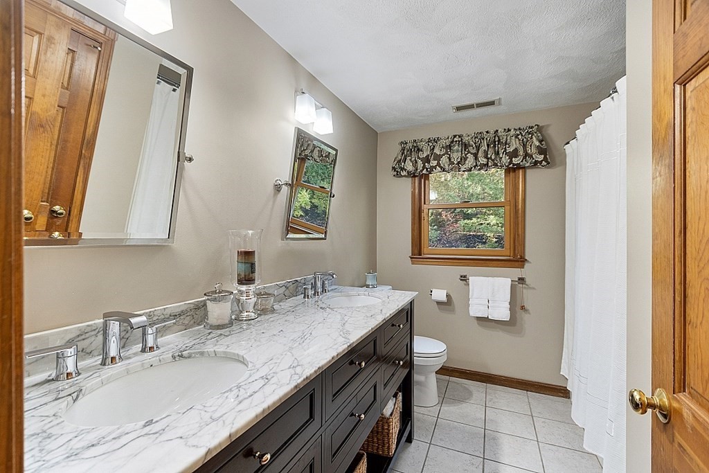 5 Abby Road Westford, MA 01886 - Photo 33 of 41 a bathroom with a granite countertop sink a mirror a vanity and a window