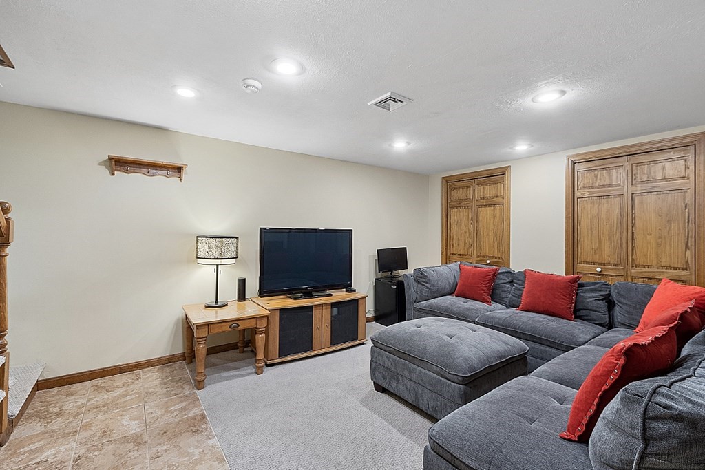 5 Abby Road Westford, MA 01886 - Photo 35 of 41 a living room with furniture and a flat screen tv