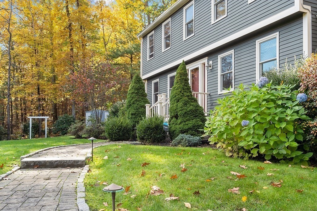 5 Abby Road Westford, MA 01886 - Photo 37 of 41 a view of a brick house with a yard and plants