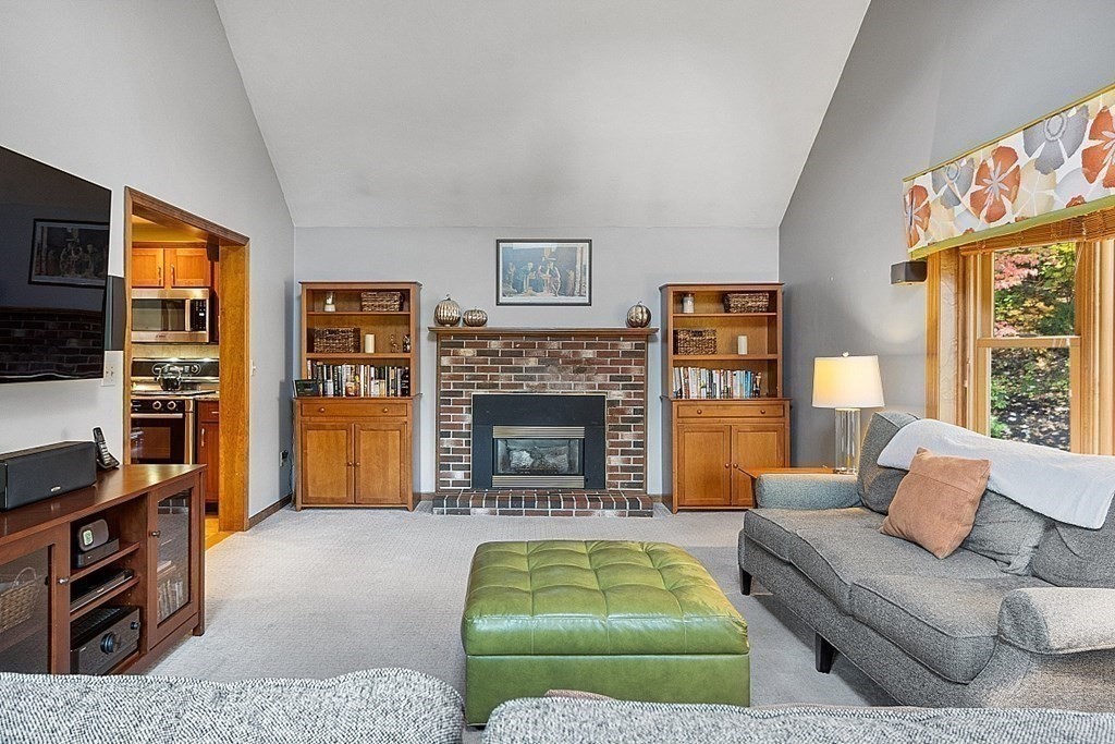 5 Abby Road Westford, MA 01886 - Photo 9 of 41 a living room with furniture and a fireplace