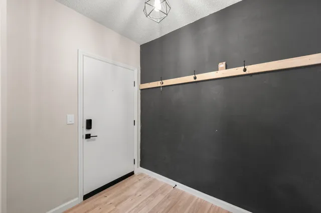 a view of a room with wooden floor