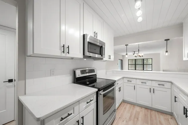 a kitchen with a sink stove and cabinets