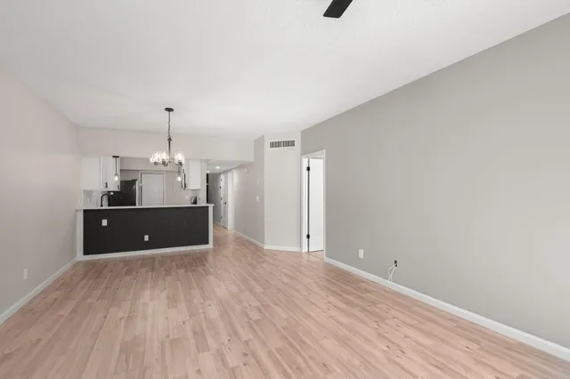 a view of a room with a sink and wooden floor