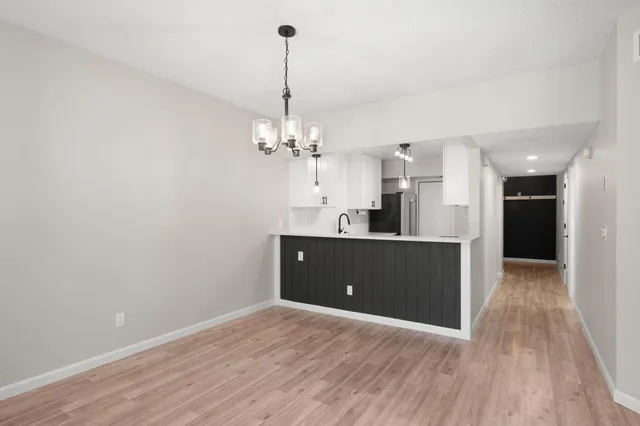 a view of a kitchen and a sink wooden floor
