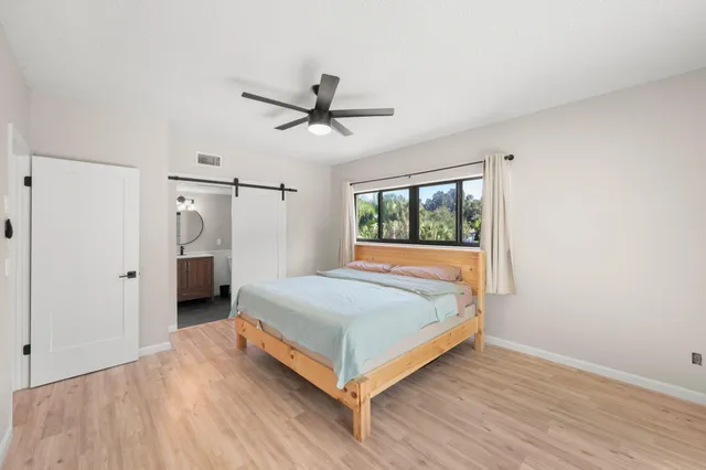 a bedroom with a bed and a window