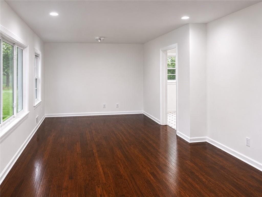 1189 Rock Cut Road Forest Park, GA 30297 - Photo 12 of 23 an empty room with wooden floor and windows