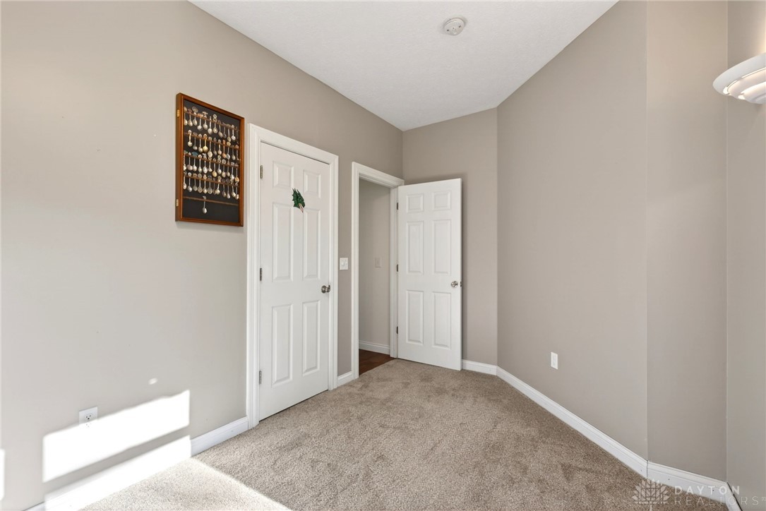 330 South Alpha Bellbrook Road Bellbrook, OH 45305 - Photo 22 of 87 This versatile room features warm carpet and multiple doorways, offering comfort and connectivity.