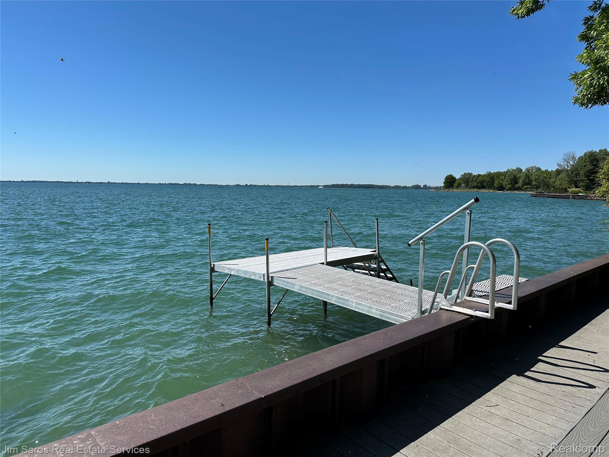 Private dock with integrated ladder and handrails, featuring direct water access