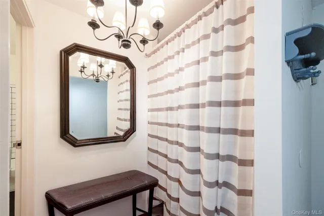 a living room with stainless steel appliances kitchen island hardwood floor and a sink