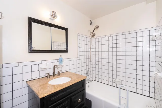 a view of a hallway with wooden floor and furniture
