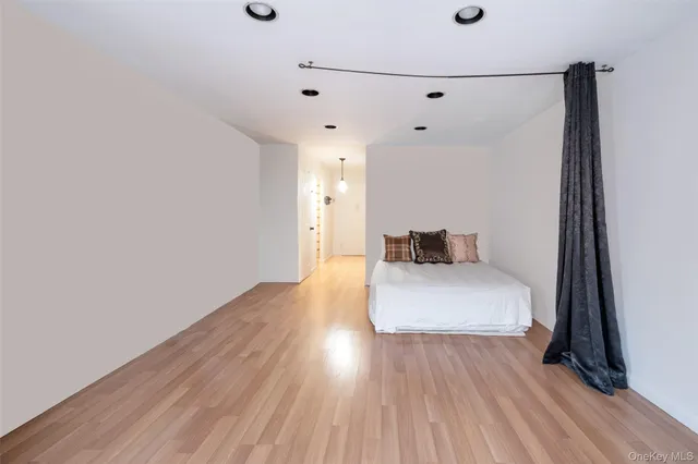 a room with a walk in closet and a mirror