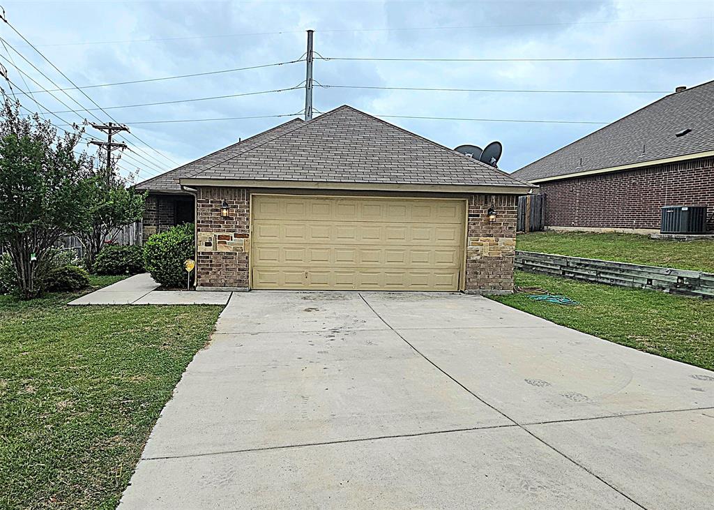 101 Hummingbird Drive Weatherford, TX 76085 - Photo 2 of 10 a front view of a house with a yard and garage