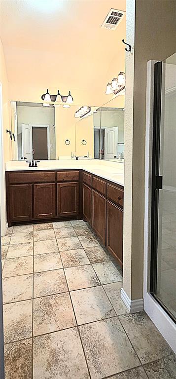 101 Hummingbird Drive Weatherford, TX 76085 - Photo 5 of 10 a bathroom with a sink vanity and a mirror