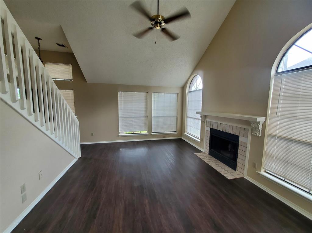 417 Antietam Way Mesquite, TX 75149 - Photo 5 of 9 an empty room with wooden floor fireplace and windows