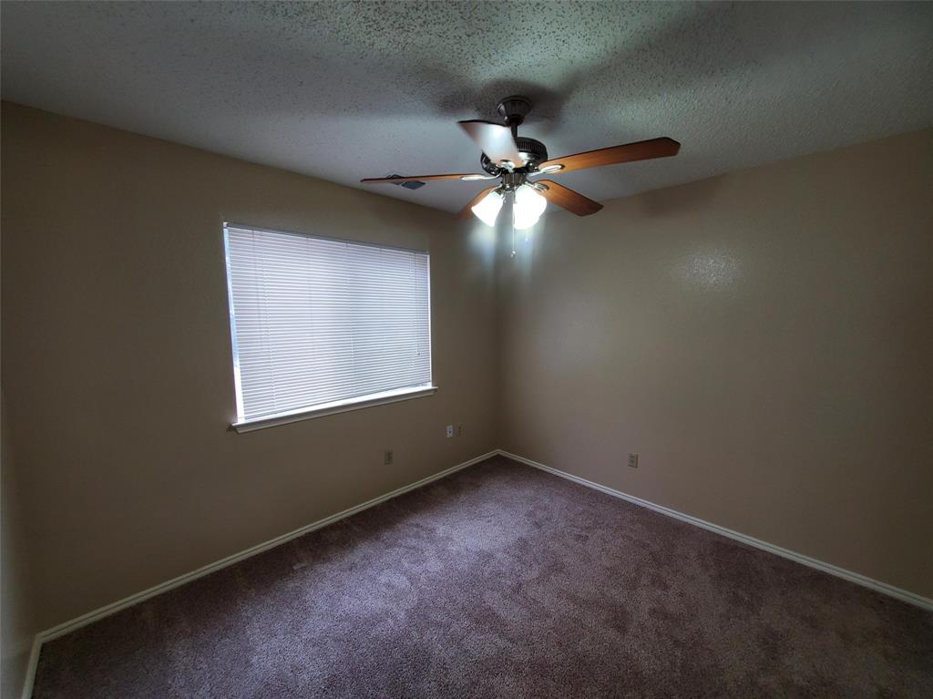 417 Antietam Way Mesquite, TX 75149 - Photo 6 of 9 an empty room with a window and a fan