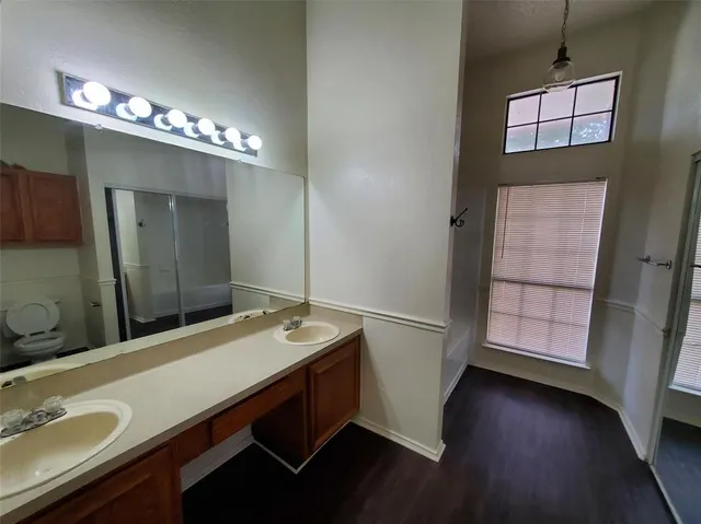 a bathroom with a sink double vanity granite and a mirror