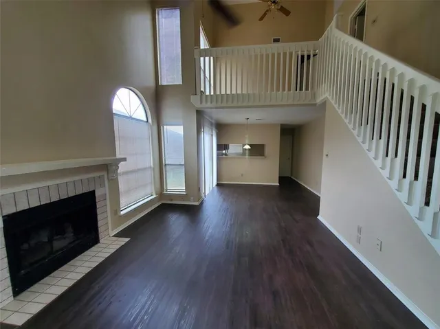 a view of an entryway with wooden floor fireplace and a window